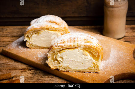 Vanilla cream roll pastry on a wooden table with smoothie Stock Photo