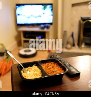 chicken tikka masala ready meal infront of tv Stock Photo