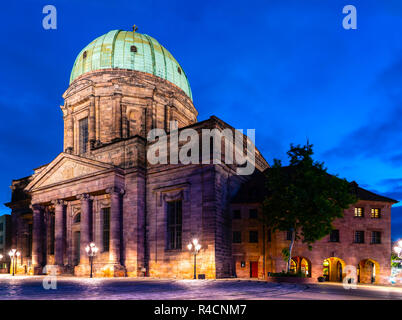 the church Sankt Elisabeth in the old town of Nuremberg illuminated in the blue hour at evening with blue sky Stock Photo