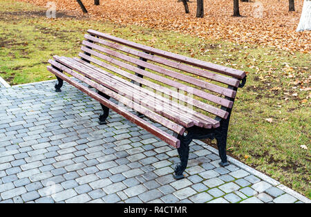 Lonely wooden bench in the autumn park Stock Photo