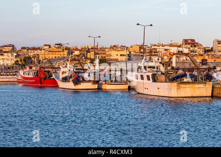 Fishing motor boat on the harbor in Palamos bay of Spain Stock Photo