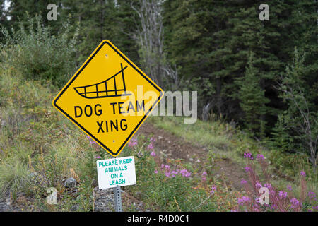 Dog Team Xing - Dog Sled team crossing road sign in Alaska Stock Photo