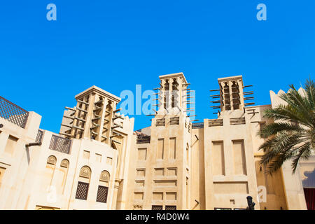 traditional Arab wind tower for air conditioning and cooling on top of building in Dubai, United Arab Emirates Stock Photo
