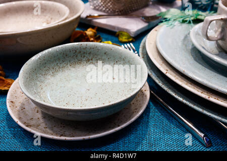 Table with dishes on a blue tablecloth Stock Photo