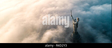 Aerial view of the Monument Motherland, shrouded in thick fog. Historical sights of Ukraine. Stock Photo