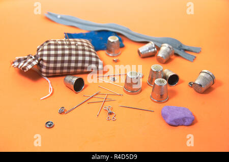Some elements necessary for sewing such as sewing needles, thimbles among others Stock Photo