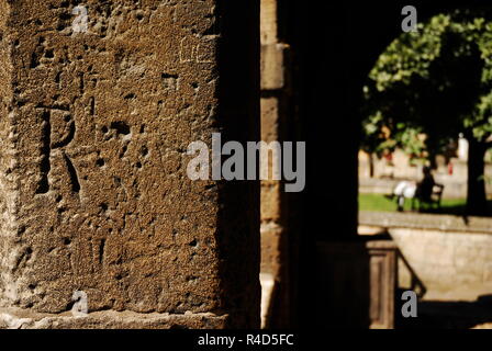 Old graffiti carved into the Cotswold stone of the market hall in the town of Chipping Campden, Gloucestershire, UK Stock Photo