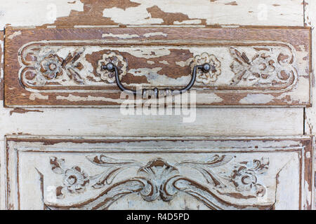 Old wooden antique chest of drawers with metal handles closeup Stock Photo