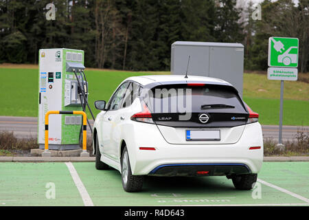 Salo, Finland - November 23, 2018: Nissan Leaf electric car charging battery at Fortum Charge & Drive Fast Charger in South of Finland, rear view.