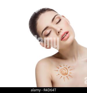 Girl with cream sun shape drawing on chest Stock Photo