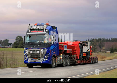 Salo, Finland - November 23, 2018: Volvo FH16 750 semi trailer of Lavettikuljetus Ylitalo & Vahtera Oy hauls Sandvik LH517 underground loader on road. Stock Photo