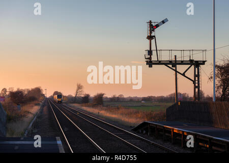 First Hull Trains class 180 DMU passing the bracket semaphore signal at Broomfleet on the line to Hull Stock Photo