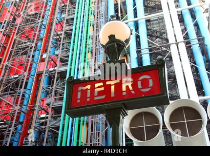 Paris, France - August 19, 2018: road sign with text METRO that means subway in french language in Paris France and Pompidou Center in Background Stock Photo