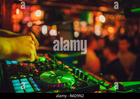 DJ remote, turntables, and hands . Night life at the club, party. Stock Photo