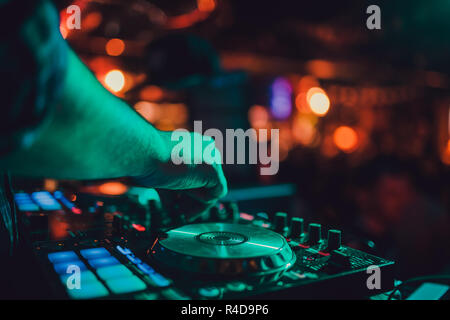 DJ remote, turntables, and hands . Night life at the club, party. Stock Photo