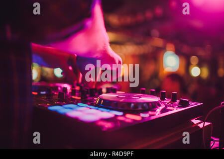 DJ remote, turntables, and hands . Night life at the club, party. Stock Photo