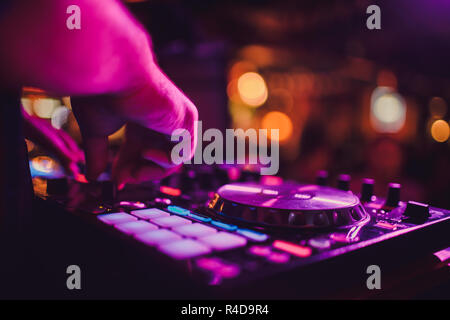 DJ remote, turntables, and hands . Night life at the club, party. Stock Photo