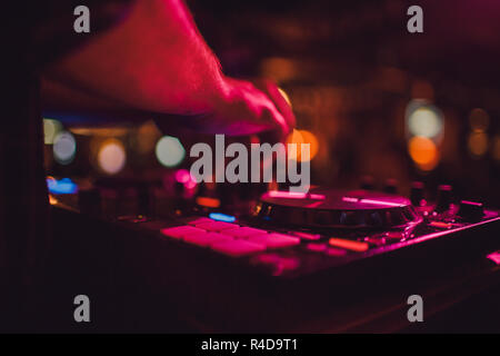 DJ remote, turntables, and hands . Night life at the club, party. Stock Photo