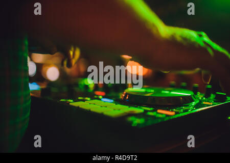 DJ remote, turntables, and hands . Night life at the club, party. Stock Photo