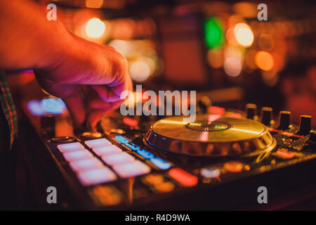 DJ remote, turntables, and hands . Night life at the club, party. Stock Photo