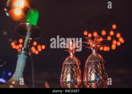 Two cocktails in the pineapple form cups on the bar counter. Stock Photo