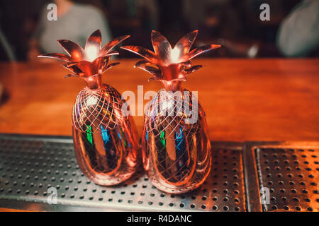 Two cocktails in the pineapple form cups on the bar counter. Stock Photo