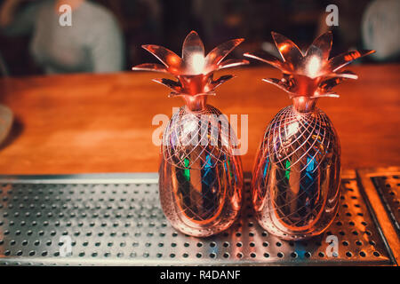 Two cocktails in the pineapple form cups on the bar counter. Stock Photo
