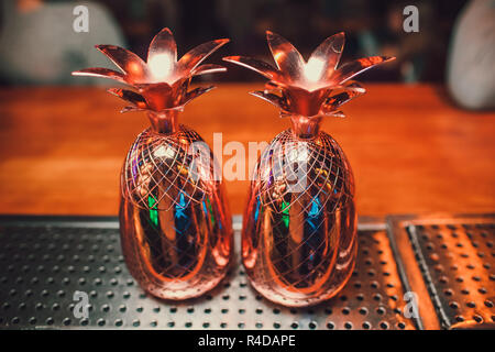 Two cocktails in the pineapple form cups on the bar counter. Stock Photo