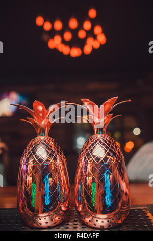 Two cocktails in the pineapple form cups on the bar counter. Stock Photo