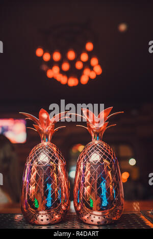 Two cocktails in the pineapple form cups on the bar counter. Stock Photo