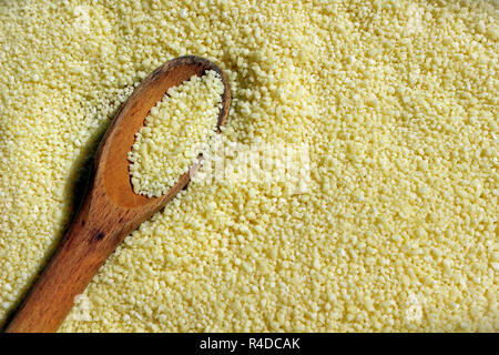 Couscous close up with a wooden spoon Stock Photo