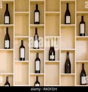 variety bottles of wine and champagne in a wooden display case in the store Stock Photo