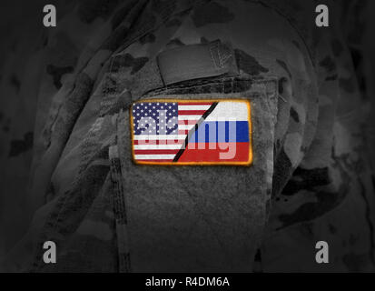 US vs Russia. Flag of United States and Russia at military uniform (collage) Stock Photo