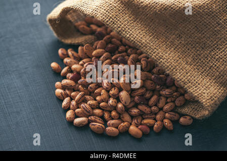 Pinto beans in burlap sack, healthy legume beans, selective focus Stock Photo