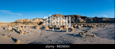 Panorama of the 'Cracked Eggs' rock field and rock formations in late afternoon sun in the Bisti Badlands in New Mexico Stock Photo