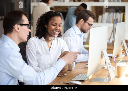 Laughing African American woman talking with colleague Stock Photo