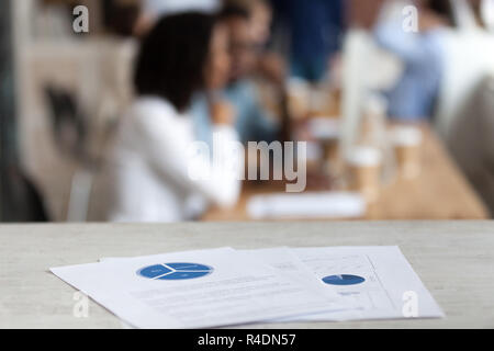 Document with financial report, pie diagram on office table Stock Photo