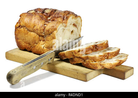 Frisian Suikerbrood (sugar bread) with knife and wooden plate isolated on white background Stock Photo