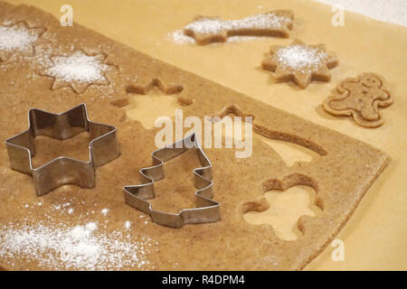 Molds for baking cakes on gingerbread dough. Christmas homemade bakery Stock Photo