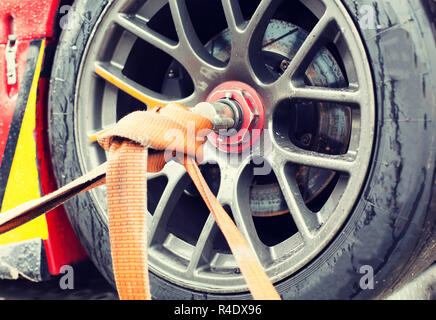 close up of race car wheel with tow rope tied to Stock Photo