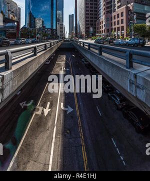 Tall buildings of downtown Los Angeles, California have traffic flowing below the street level on Grand Avenue on November 25, 2018. Stock Photo