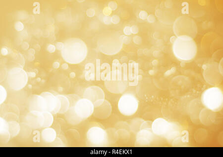 A sparkling bokeh background blur in gold and white. Stock Photo