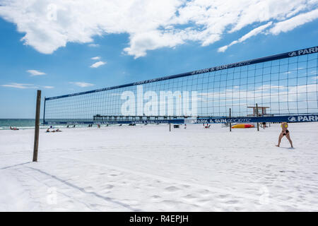 Fort Walton Beach, USA - April 24, 2018: Okaloosa Island fishing pier in Florida in Panhandle, Gulf of Mexico during sunny day, sand beach volleyball  Stock Photo