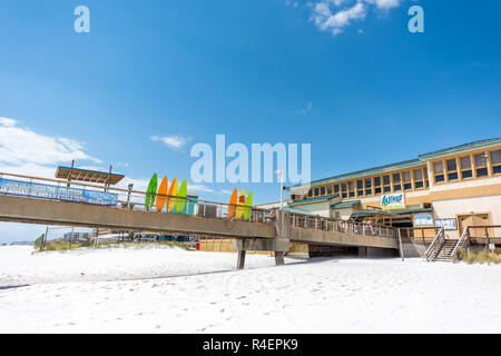 Fort Walton Beach, USA - April 24, 2018: Okaloosa Island fishing pier in Florida in Panhandle, Gulf of Mexico during sunny day, colorful surfboards, r Stock Photo