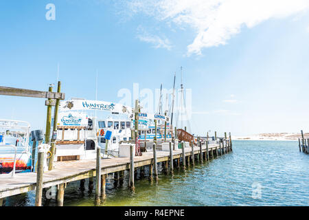 Destin, USA - April 24, 2018: City town Harborwalk village Harbor charter boat marina dock during sunny day in Florida panhandle gulf of mexico Stock Photo