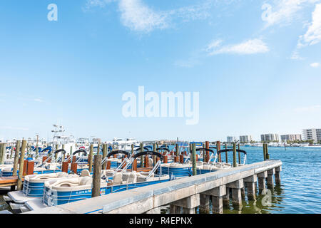 Destin, USA - April 24, 2018: City town Harborwalk village Harbor charter boat marina, wharf, dock pier during sunny day in Florida panhandle gulf of  Stock Photo