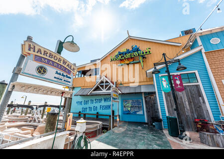 Destin, USA - April 24, 2018: Harborwalk during sunny day in Florida panhandle gulf of mexico, Margaritaville restaurant, bar at marina, wharf seaside Stock Photo