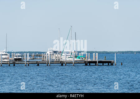 Fort Myers, USA - April 29, 2018: Boats in marina harbor dock on Caloosahatchee River during sunny day in Florida gulf of mexico coast, pier, nobody Stock Photo