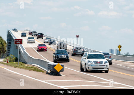 Sanibel Island, USA - April 29, 2018: Beach during sunny day with toll bridge highway causeway road and cars traffic in holiday vacation destination Stock Photo