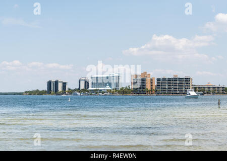 Fort Myers Beach, USA city cityscape skyline with condo apartment buildings during sunny day in Florida gulf of mexico coast, bay view from Sanibel Is